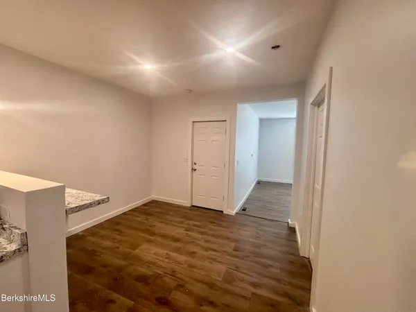 a view of hallway with wooden floor