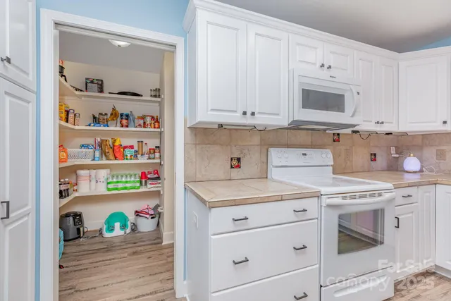 a living room with a fireplace and a flat screen tv
