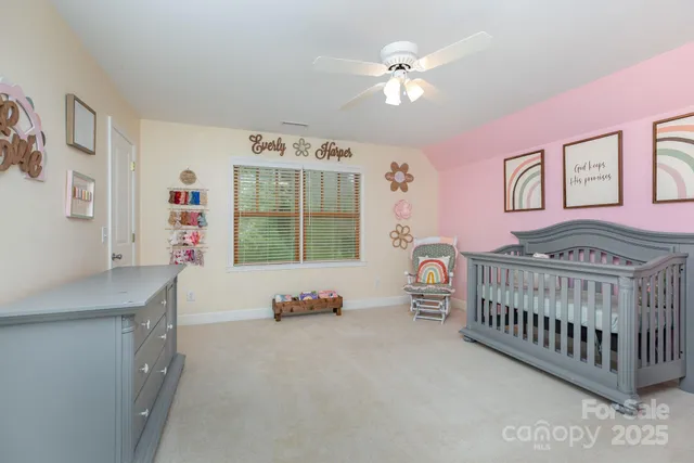 a room with a baby bed baby crib and a dresser