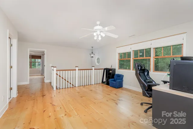 a bedroom with furniture and a flat screen tv
