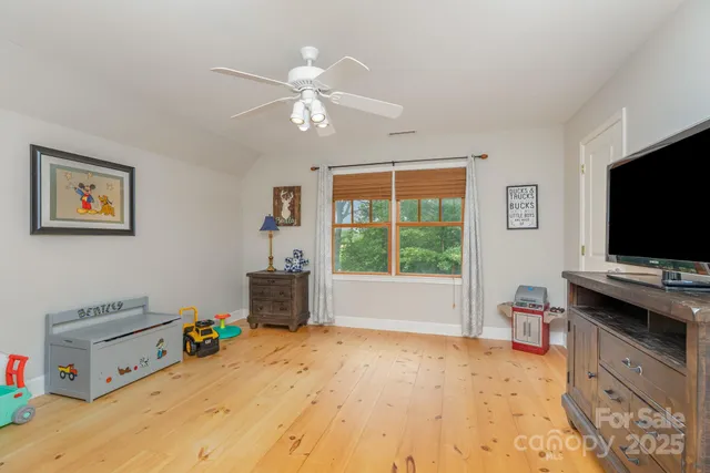a room with a bed and a flat screen tv