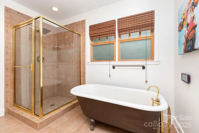 a living room with furniture and floor to ceiling windows