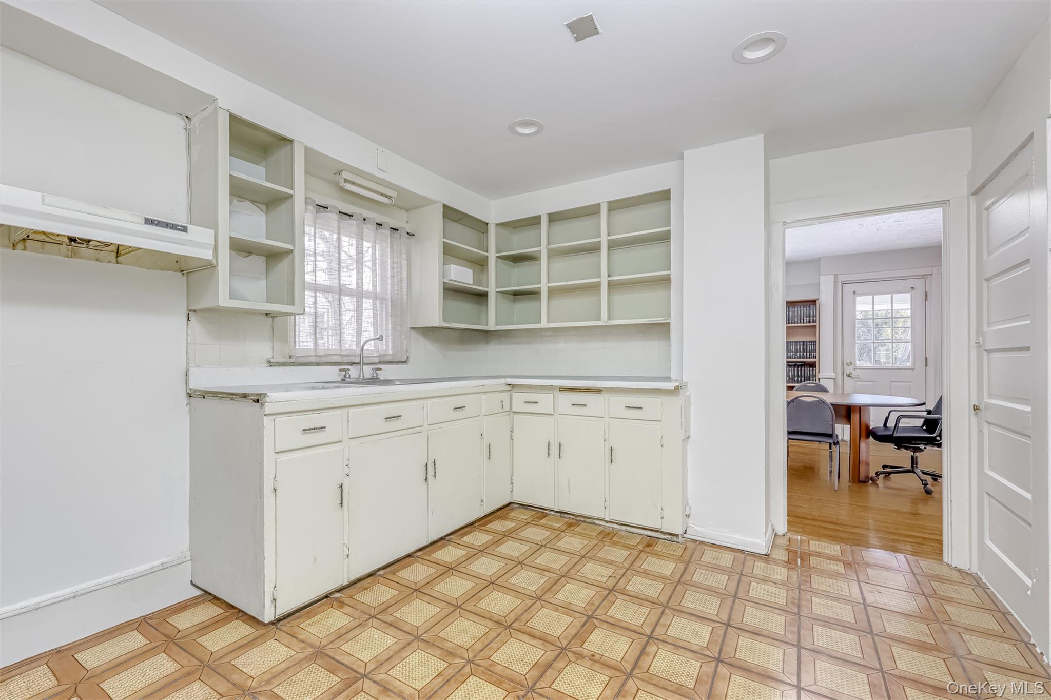 313 North Main Street Spring Valley, NY 10977 - Photo 8 of 19 Kitchen with open shelves, light countertops, an office area, and white cabinetry