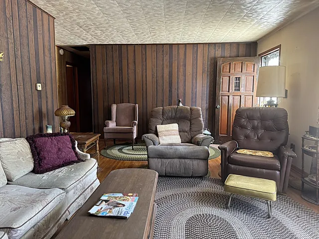 a view of a livingroom with furniture and a window