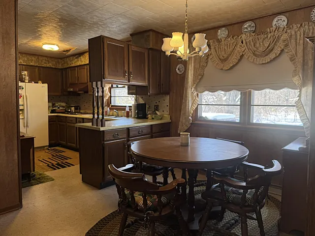 a kitchen with a table and chairs