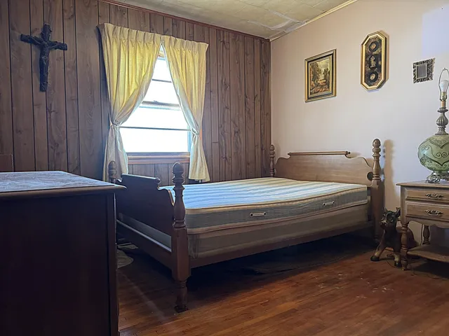 a bedroom with a bed and a shower