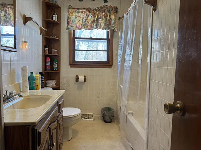 a view of a hallway with closet and cabinet