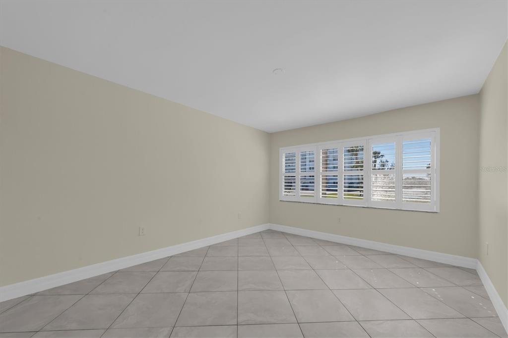 8 Glencoe Place, Unit 105 Dunedin, FL 34698 - Photo 13 of 44 an empty room with a window