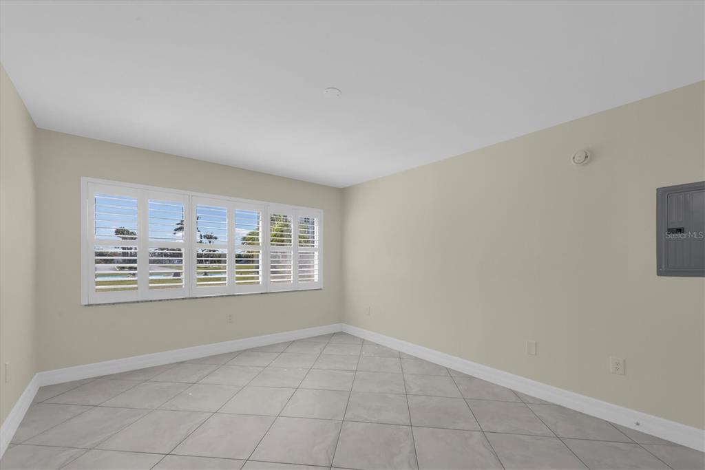 8 Glencoe Place, Unit 105 Dunedin, FL 34698 - Photo 14 of 44 a view of an empty room with a window