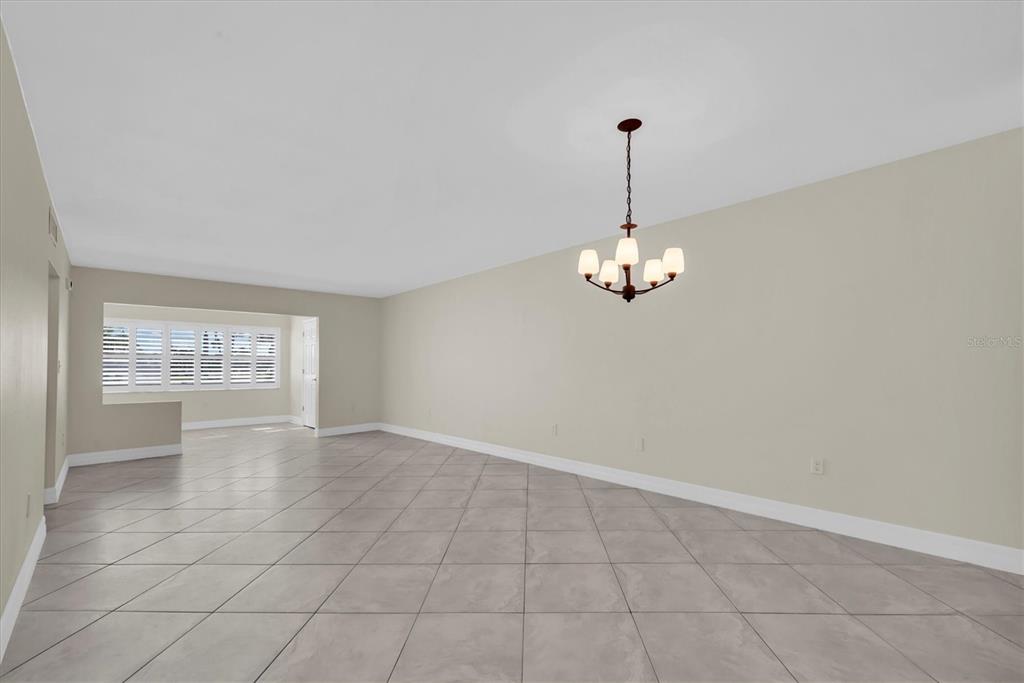 8 Glencoe Place, Unit 105 Dunedin, FL 34698 - Photo 18 of 44 a view of an empty room with a window