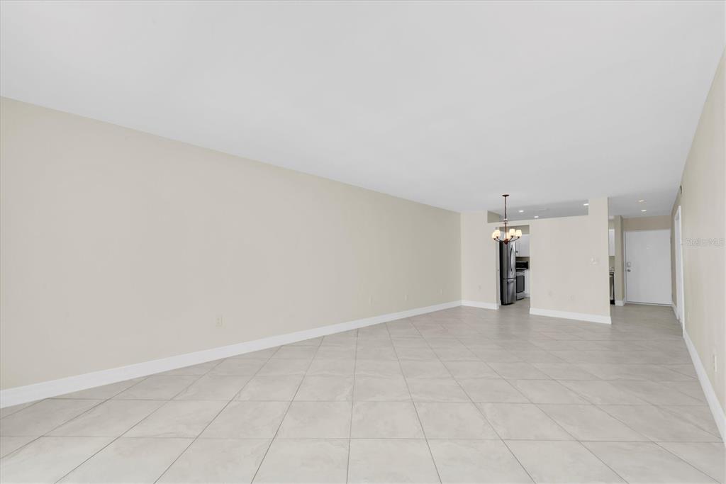 8 Glencoe Place, Unit 105 Dunedin, FL 34698 - Photo 19 of 44 an empty room with a empty space and windows