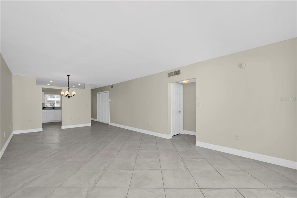 8 Glencoe Place, Unit 105 Dunedin, FL 34698 - Photo 20 of 44 an empty room with a cabinet and mirrors