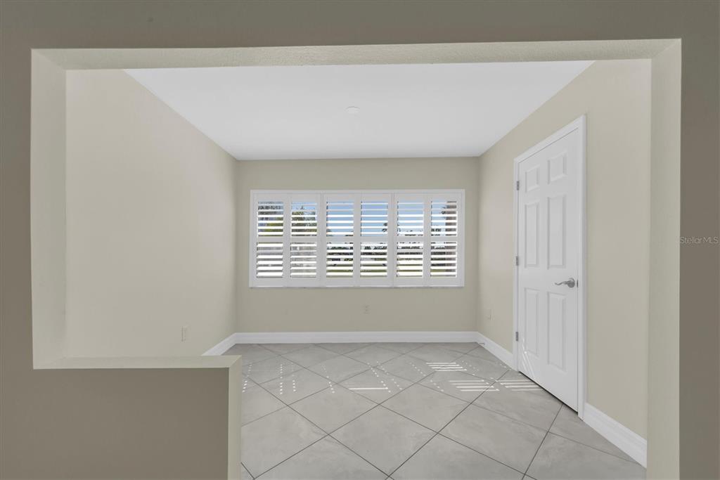 8 Glencoe Place, Unit 105 Dunedin, FL 34698 - Photo 22 of 44 a view of an empty room with a window