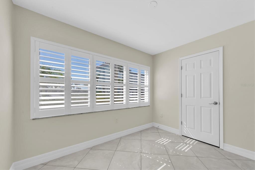8 Glencoe Place, Unit 105 Dunedin, FL 34698 - Photo 23 of 44 a view of an empty room with a window