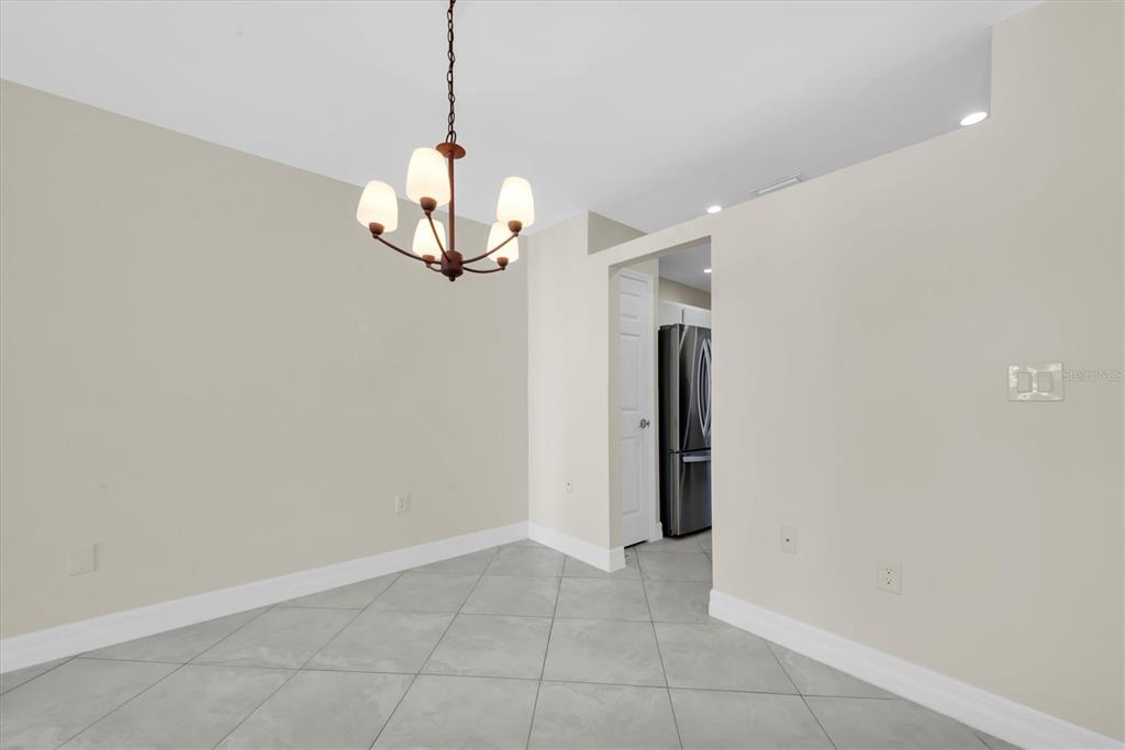 8 Glencoe Place, Unit 105 Dunedin, FL 34698 - Photo 24 of 44 a view of a hallway with a chandelier