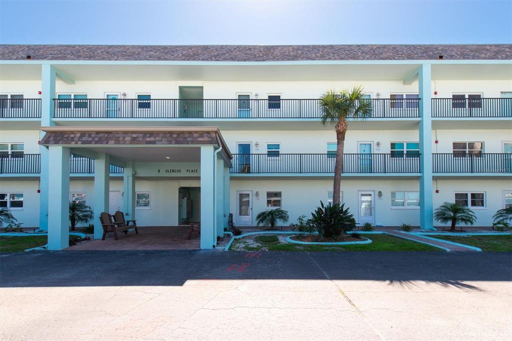 8 Glencoe Place, Unit 105 Dunedin, FL 34698 - Photo 32 of 44 a front view of a building with outdoor space