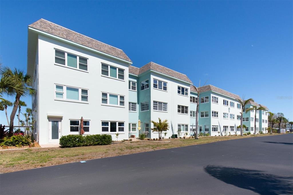 8 Glencoe Place, Unit 105 Dunedin, FL 34698 - Photo 43 of 44 a front view of a building with street view