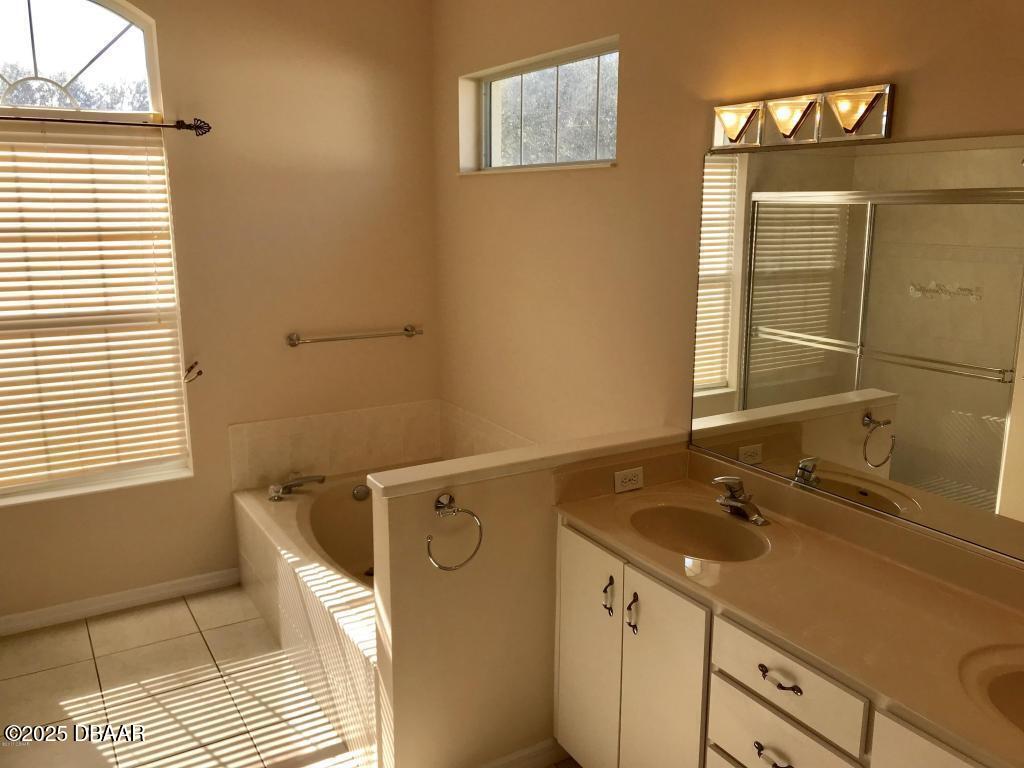 90 Buschman Drive Ponce Inlet, FL 32127 - Photo 11 of 37 a bathroom with a sink and a mirror