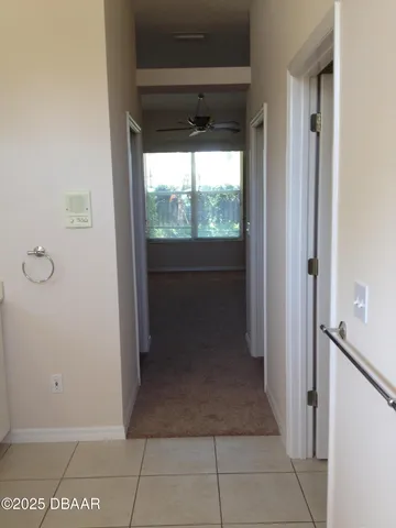 a view of a room with furniture and a window