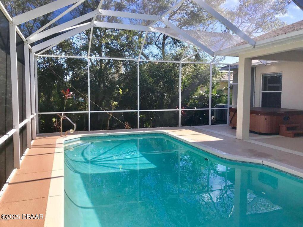 90 Buschman Drive Ponce Inlet, FL 32127 - Photo 27 of 37 a view of a house with backyard and swimming pool