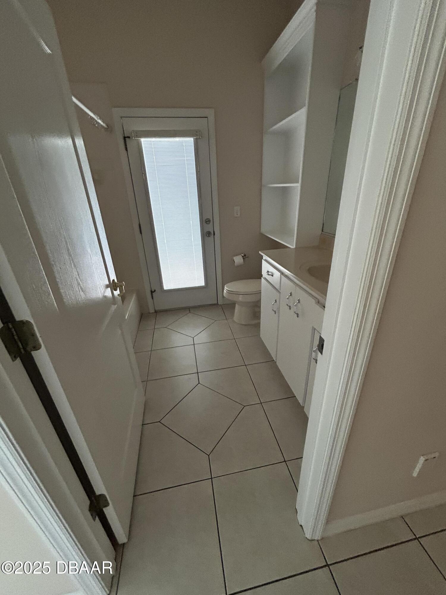90 Buschman Drive Ponce Inlet, FL 32127 - Photo 30 of 37 a bathroom with a sink a toilet and mirror
