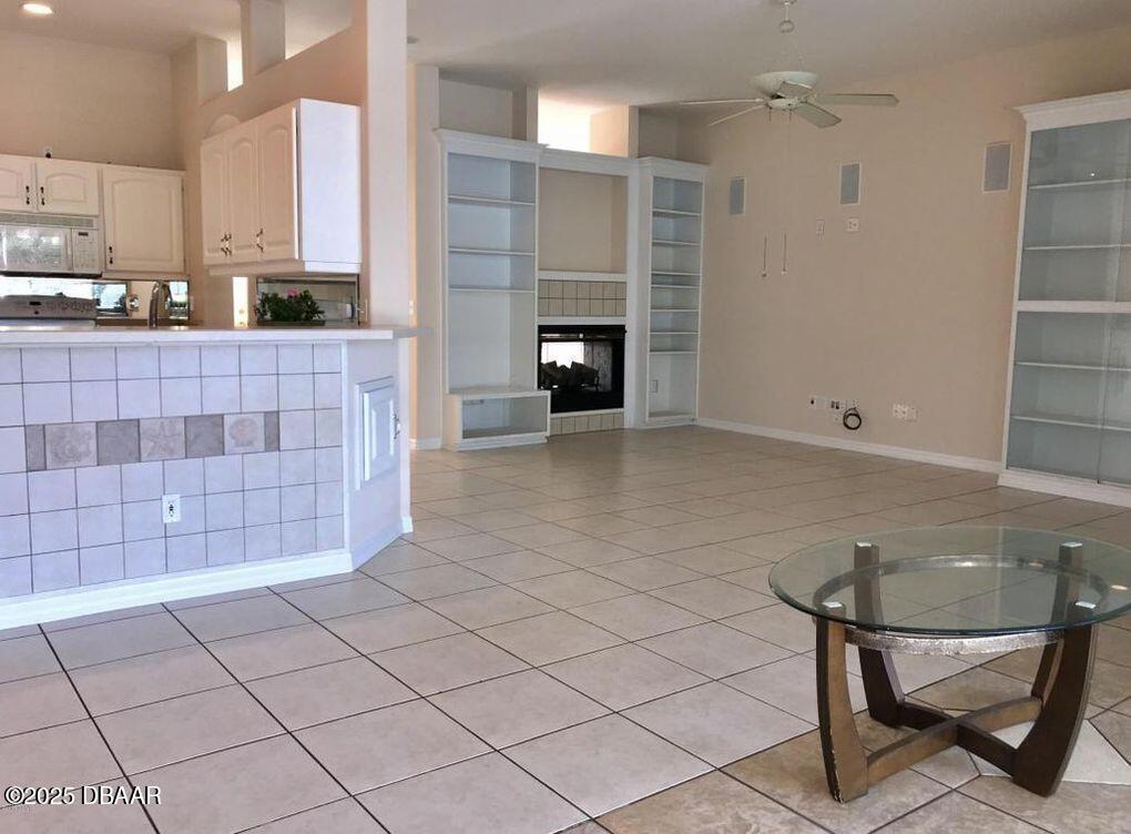 90 Buschman Drive Ponce Inlet, FL 32127 - Photo 5 of 37 a kitchen with granite countertop a sink and a stove