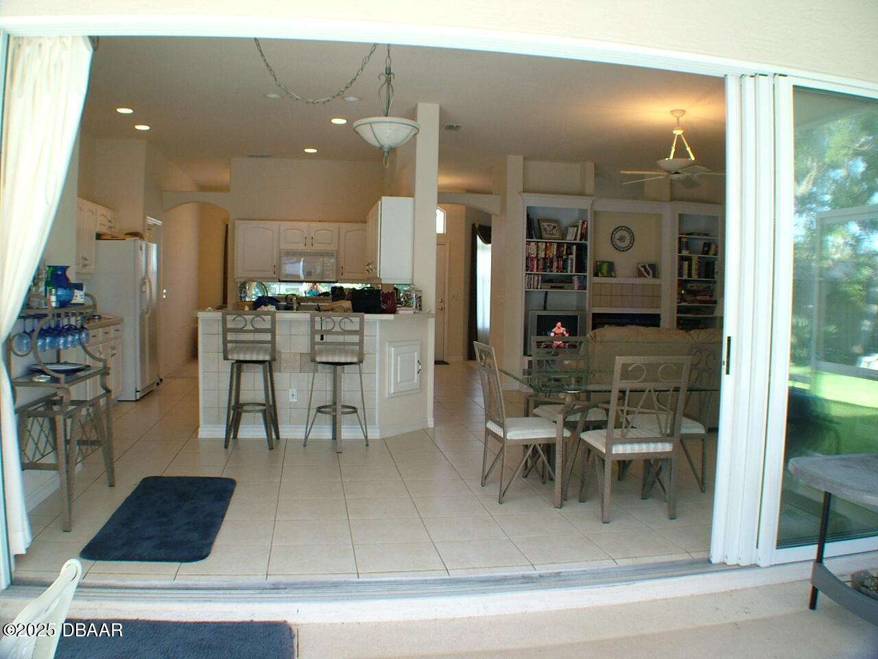 90 Buschman Drive Ponce Inlet, FL 32127 - Photo 8 of 37 a kitchen with a dining table chairs and white appliances