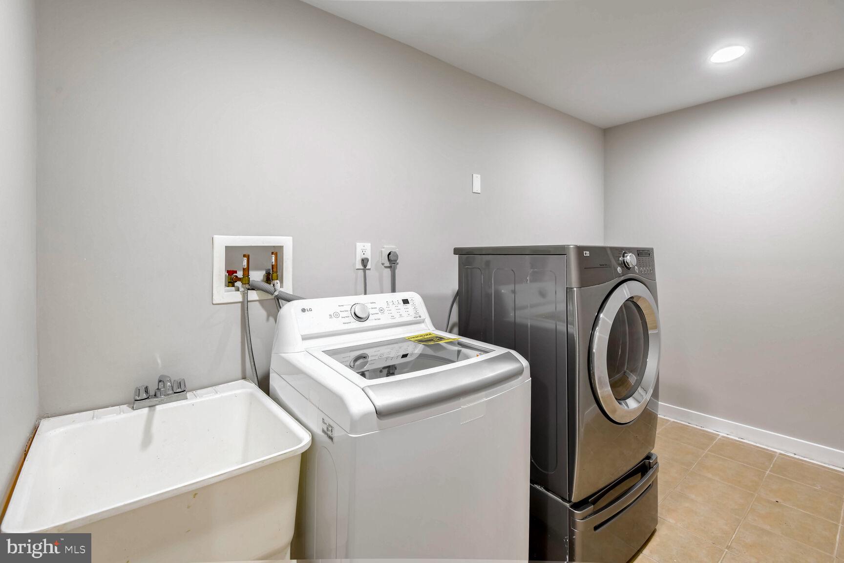 14645 Good Hope Road Silver Spring, MD 20905 - Photo 22 of 26 Modern laundry space with sleek appliances.