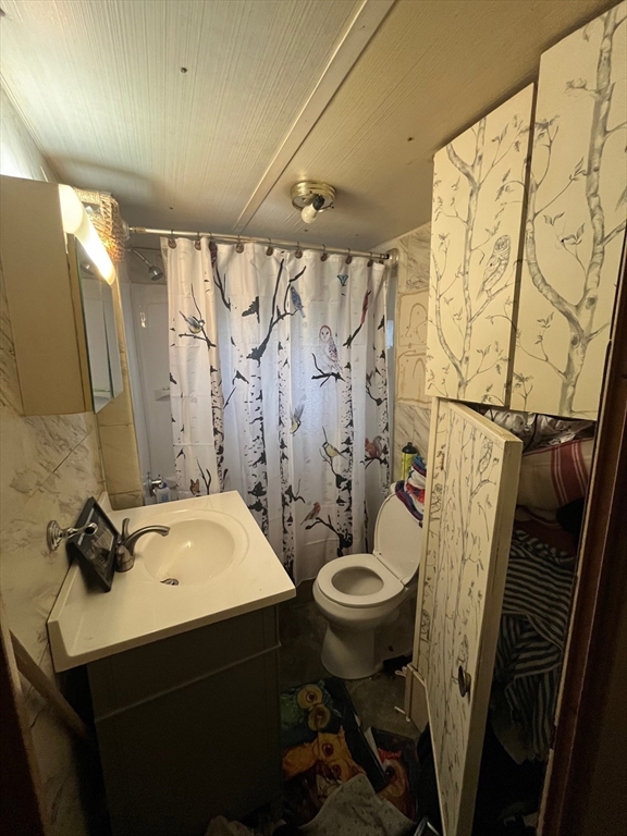 189 Springfield Road, Unit 23 Westfield, MA 01085 - Photo 9 of 14 a bathroom with a sink a toilet and shower