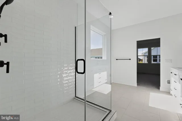 a bathroom with a shower and a sink