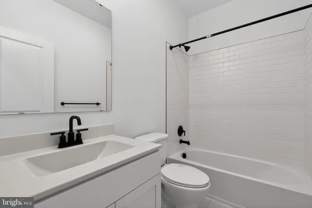 a bathroom with a sink a toilet and a bathtub