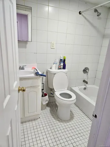 a white toilet sitting next to a bathroom sink and tub
