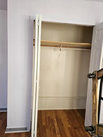a kitchen with stainless steel appliances wooden floors and wooden cabinets