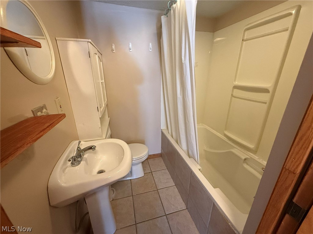 6784 Old Zoarville Road Northeast Dover, OH 44622 - Photo 32 of 50 Full bathroom with tiled shower / bath combo and light tile patterned floors