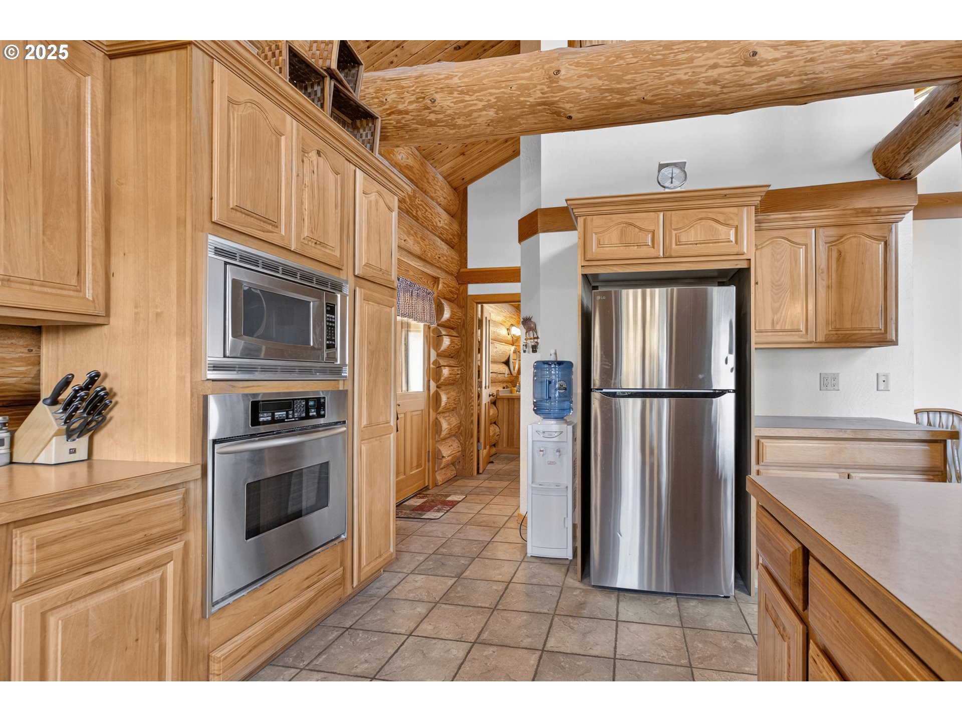 89112 Sky High Drive Springfield, OR 97478 - Photo 12 of 47 a kitchen with stainless steel appliances granite countertop a refrigerator a stove and a sink with wooden cabinets