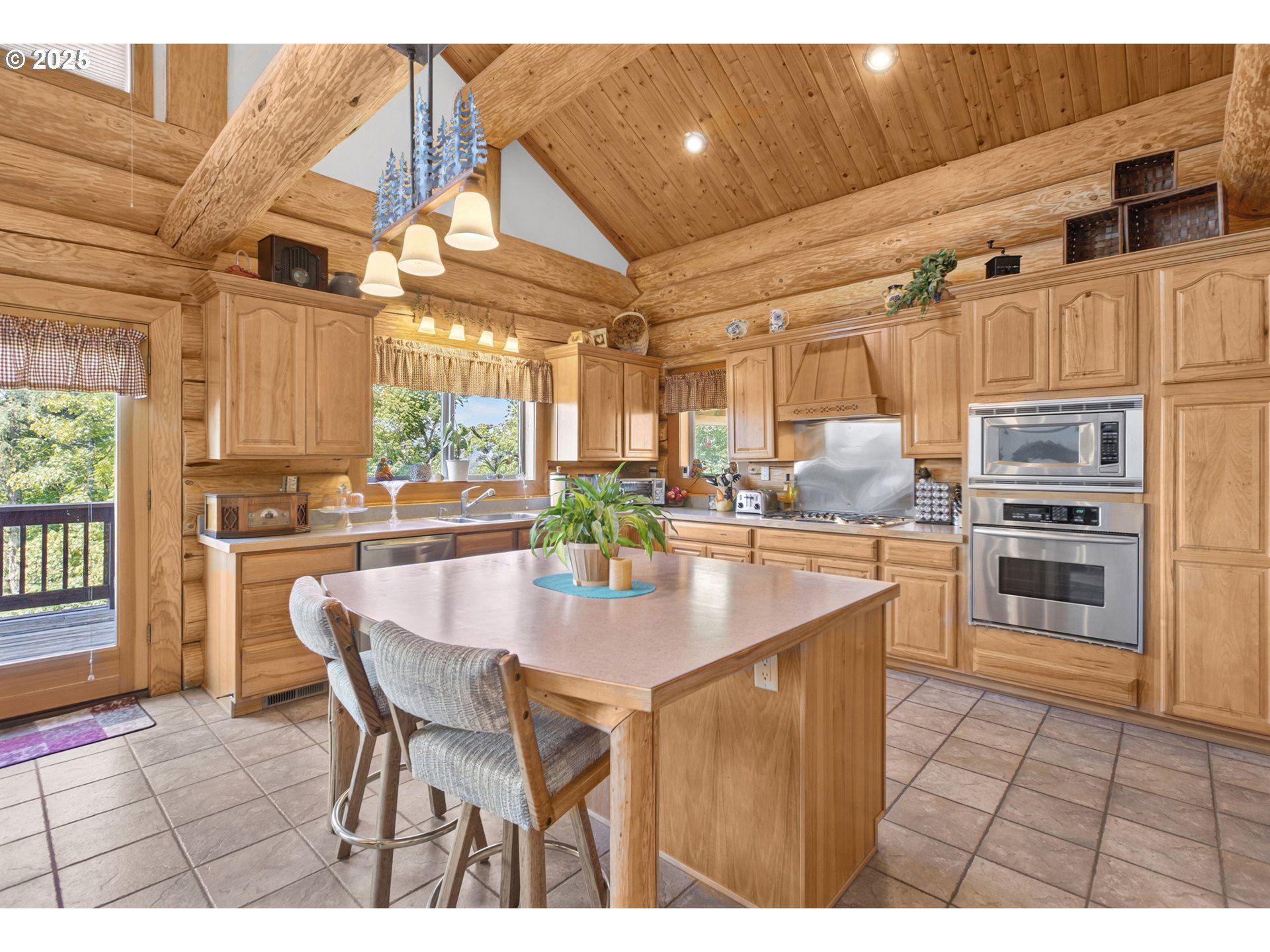 89112 Sky High Drive Springfield, OR 97478 - Photo 13 of 47 a kitchen with stainless steel appliances kitchen island granite countertop a table chairs and a refrigerator