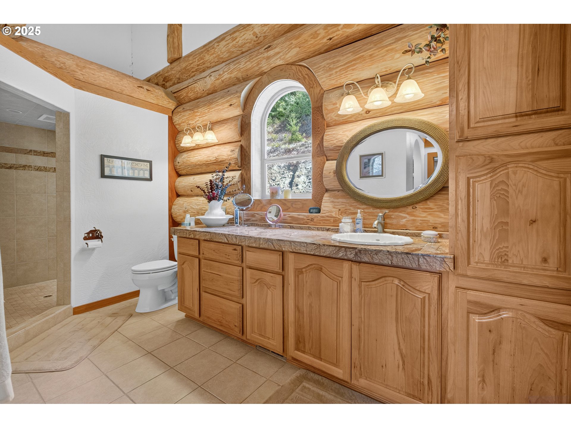 89112 Sky High Drive Springfield, OR 97478 - Photo 19 of 47 a bathroom with a granite countertop toilet a sink and a mirror