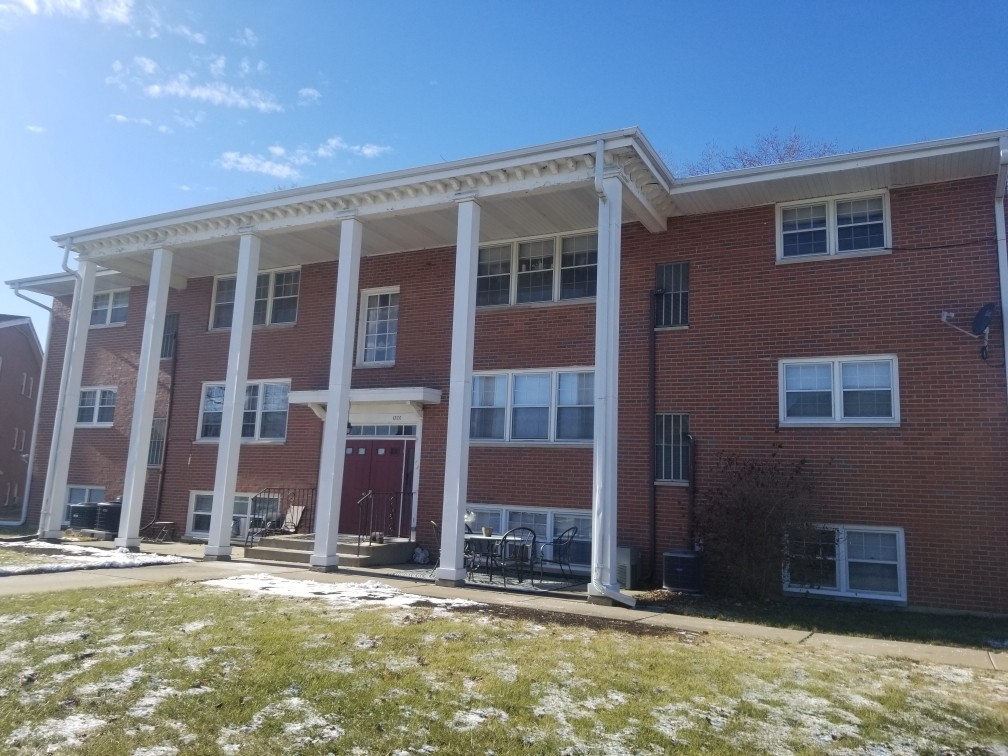 a view of a brick house with a large windows