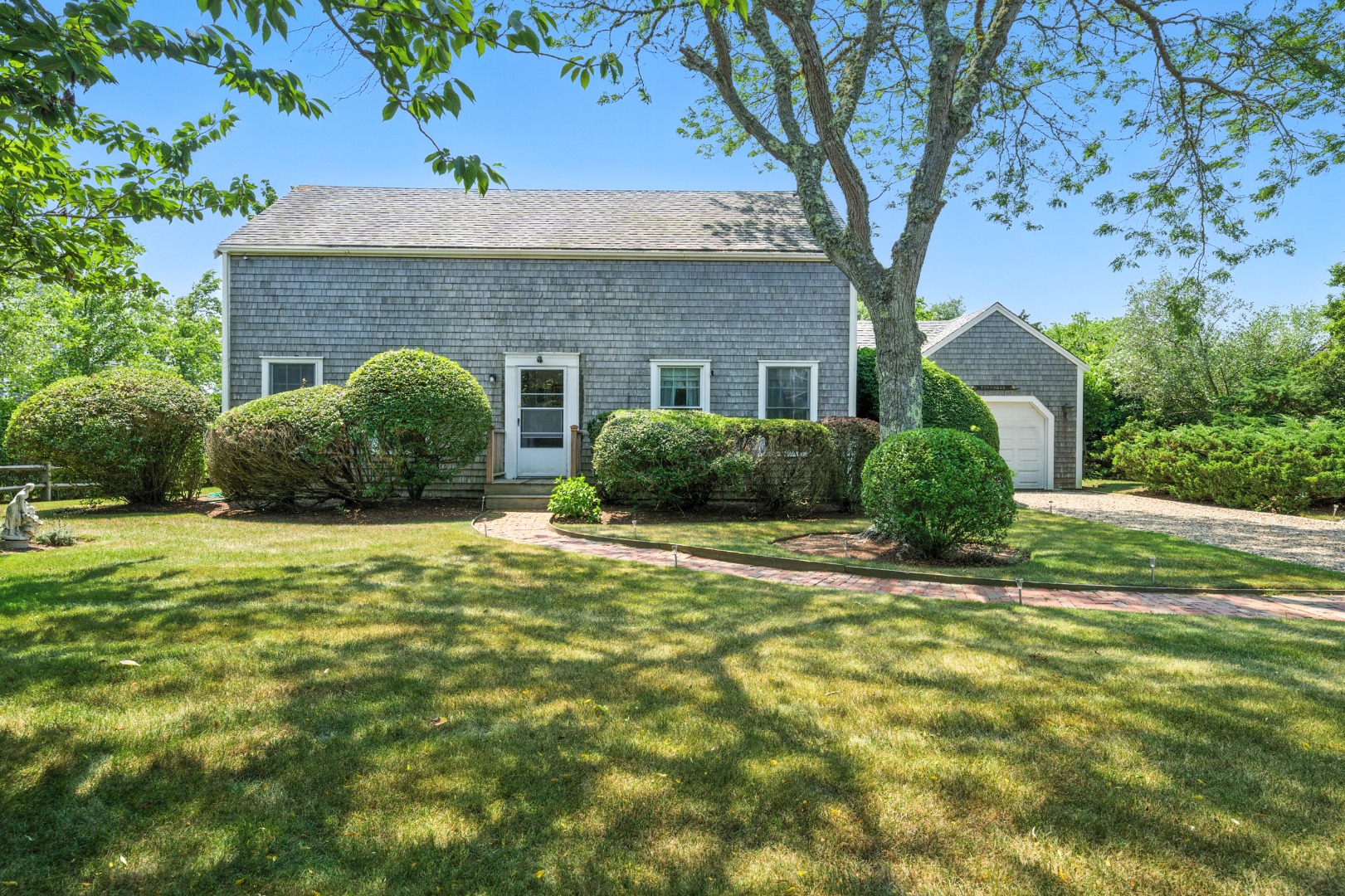 10 Meadow View Drive Nantucket, MA 02554 - Photo 3 of 48 a front view of a house with a garden