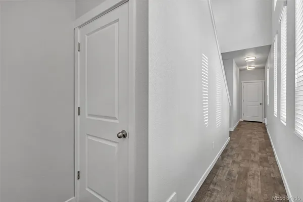 a view of a hallway with wooden floor