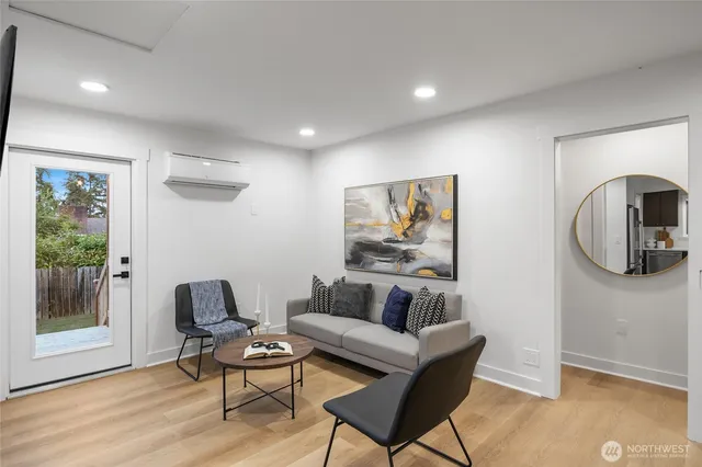 a living room with furniture and a wooden floor
