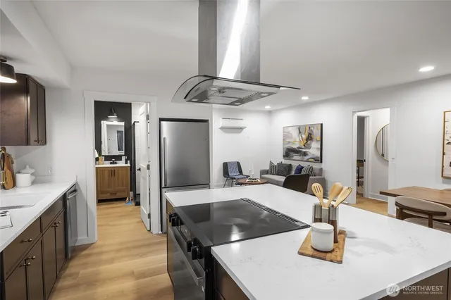 a kitchen with a sink a counter top space and stainless steel appliances