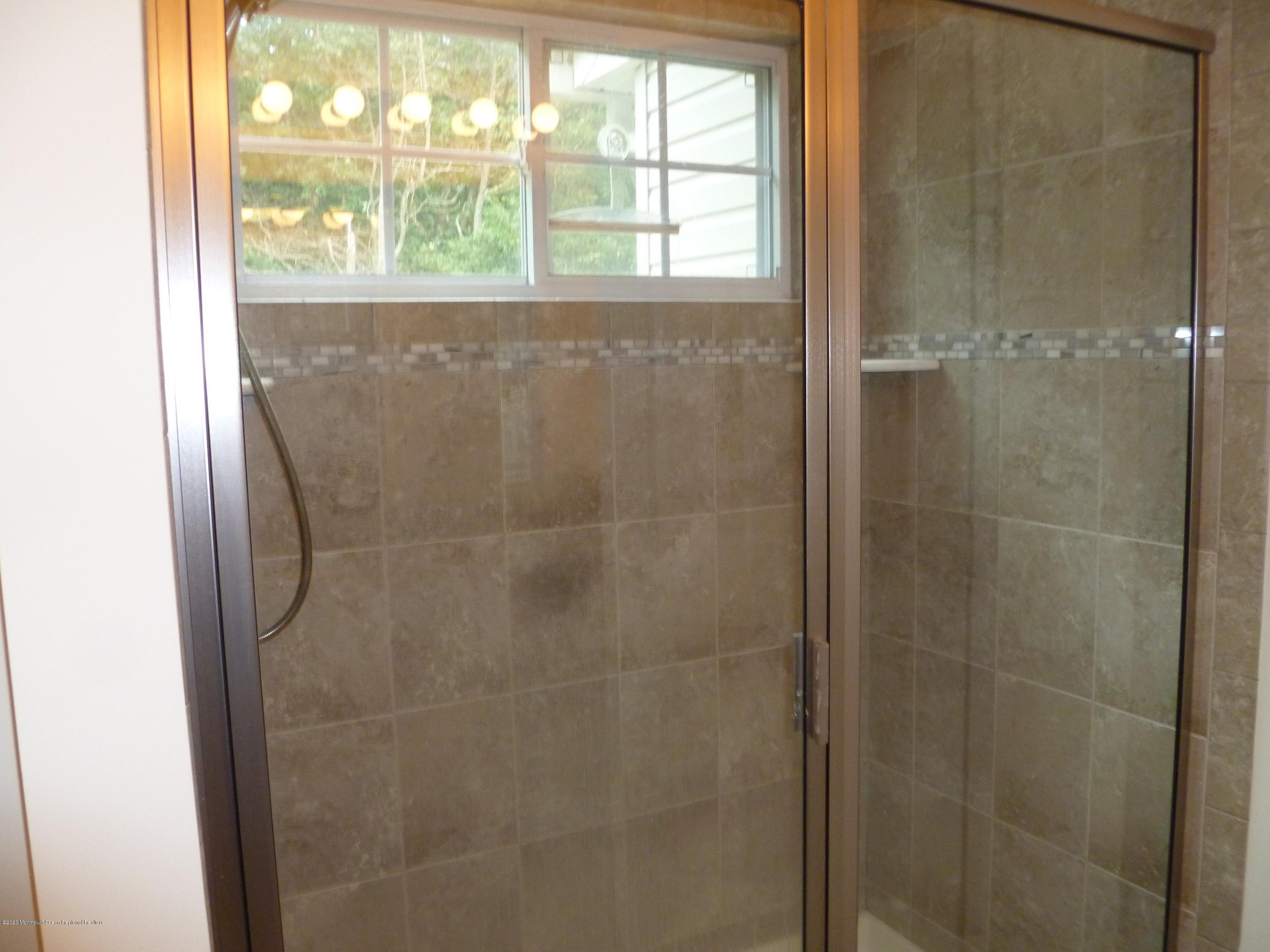 28 Santa Rosa Lane Tinton Falls, NJ 07753 - Photo 11 of 12 a bathroom with a glass shower door