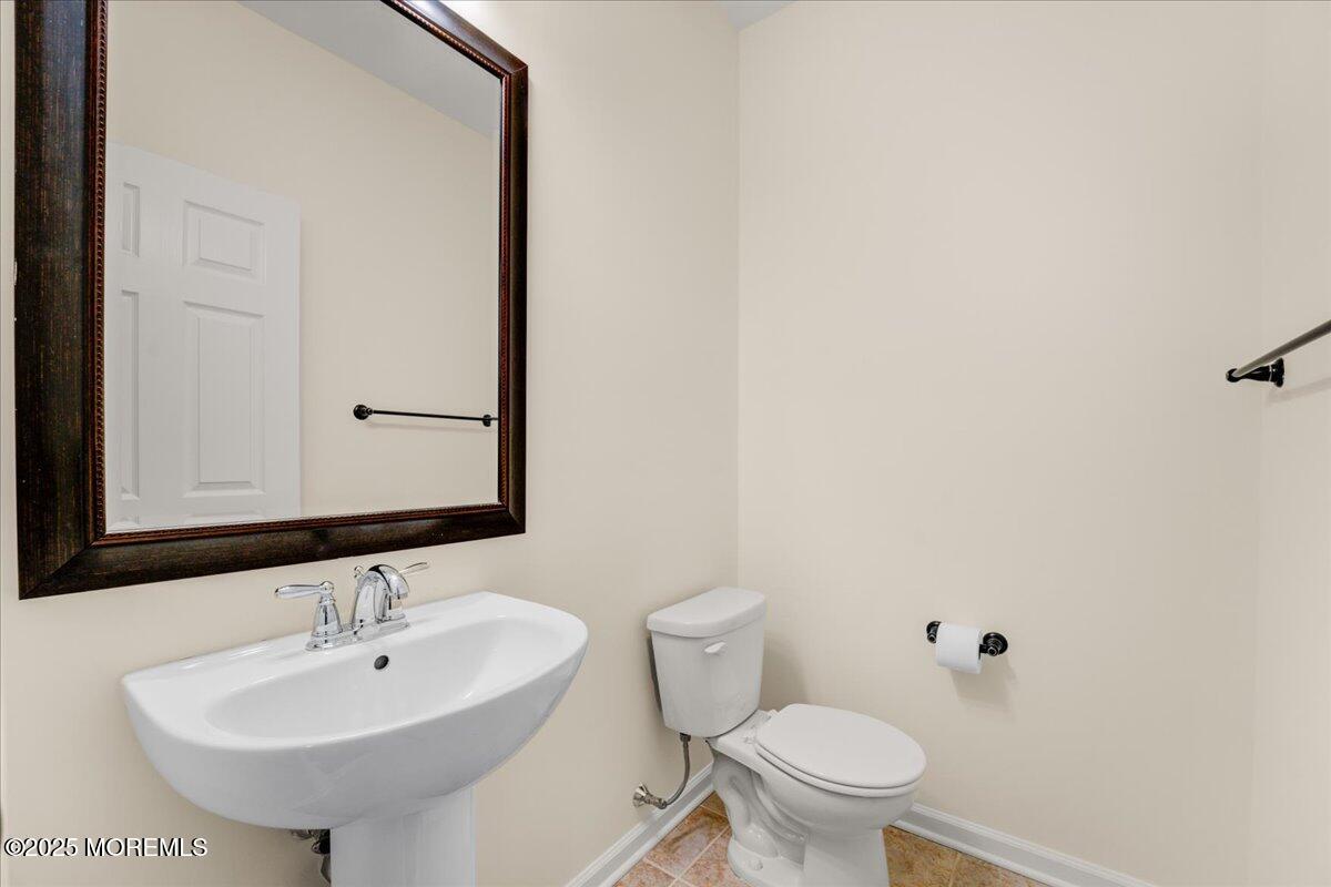 28 Santa Rosa Lane Tinton Falls, NJ 07753 - Photo 12 of 26 a bathroom with a sink a toilet and mirror