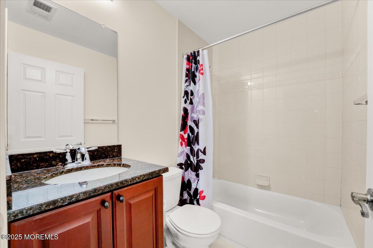 28 Santa Rosa Lane Tinton Falls, NJ 07753 - Photo 15 of 26 a bathroom with a granite countertop sink a toilet and shower