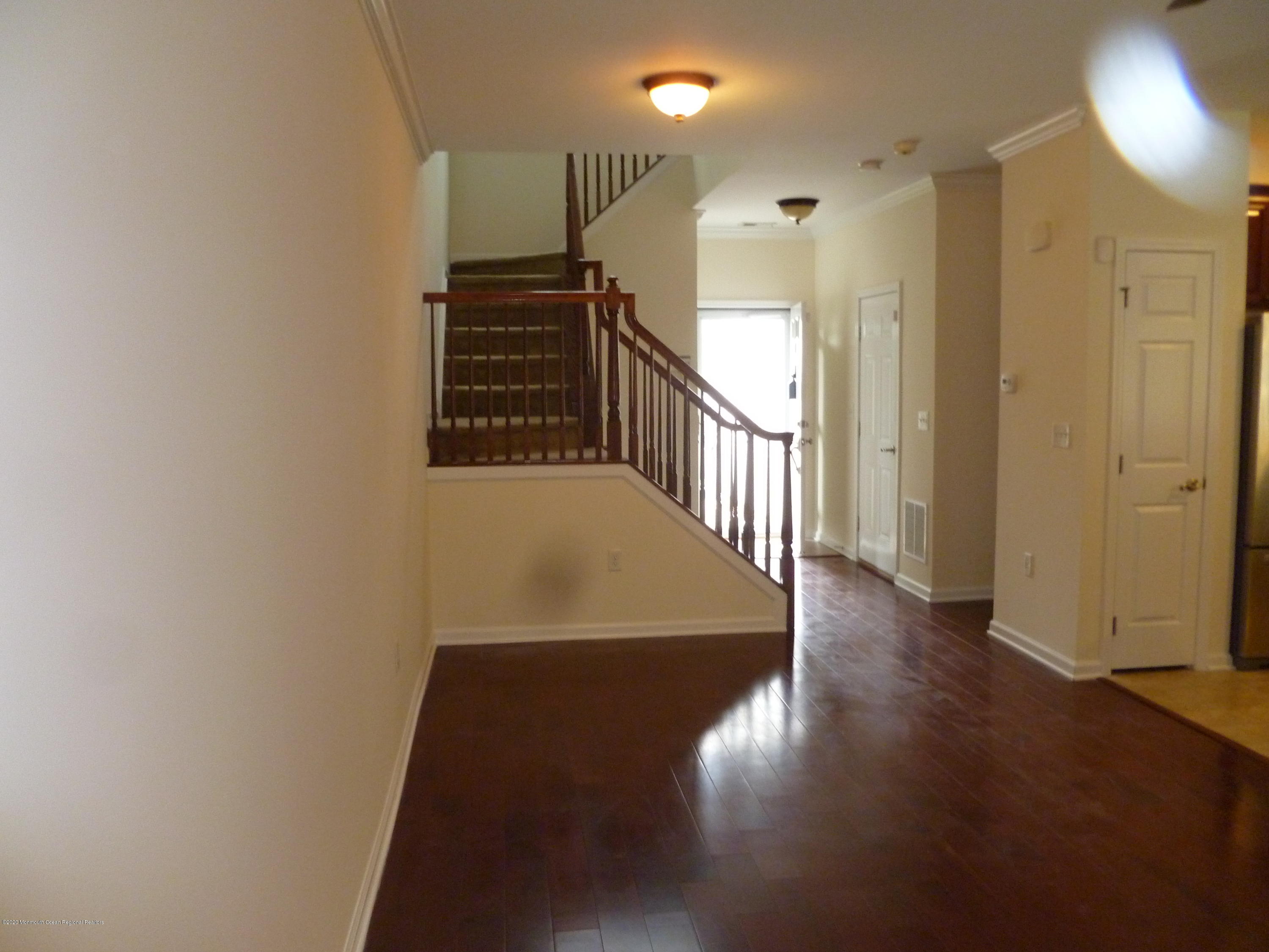 28 Santa Rosa Lane Tinton Falls, NJ 07753 - Photo 5 of 12 a view of a hallway with wooden floor