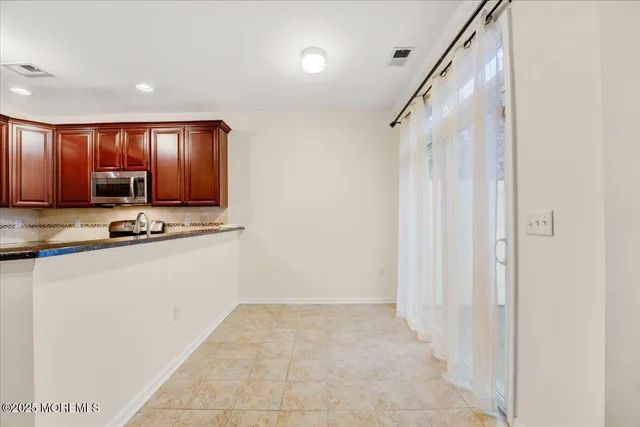 a view of kitchen with wooden floor and electronic appliances