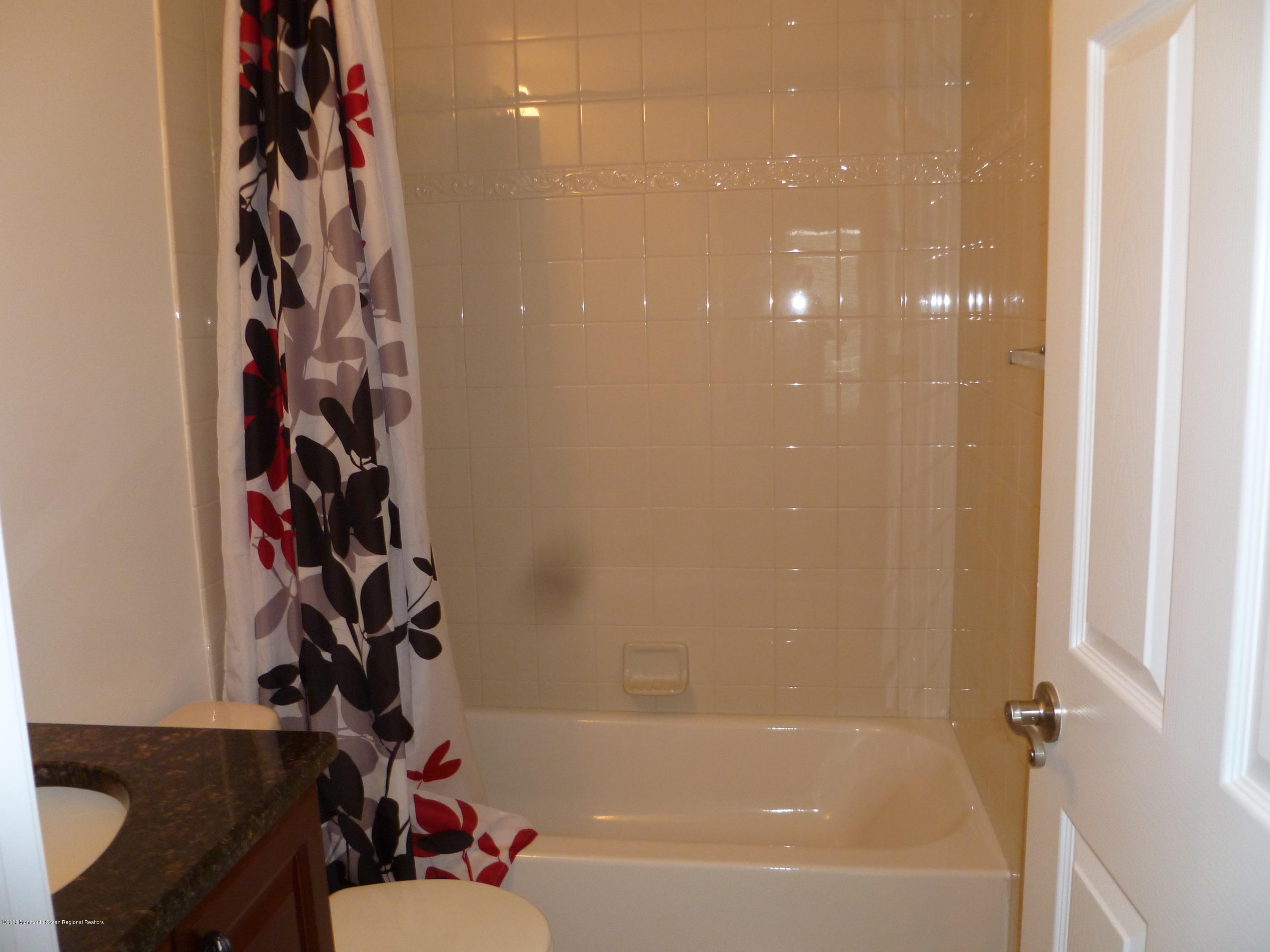 28 Santa Rosa Lane Tinton Falls, NJ 07753 - Photo 8 of 12 a bathroom with a bathtub and a shower