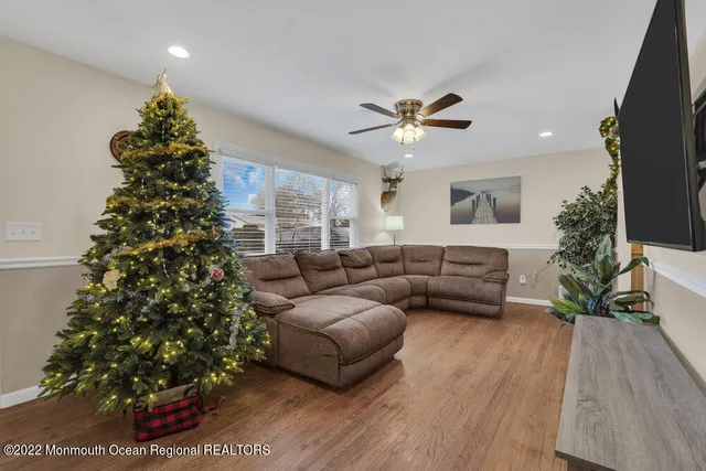 a living room with furniture and a christmas tree