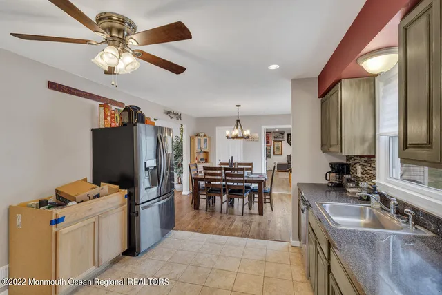 a kitchen with stainless steel appliances granite countertop a sink a stove and refrigerator